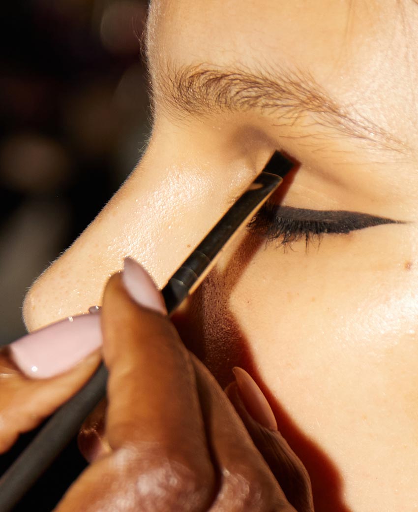 Lancome Makeup Artist Shieka Daley applying eyeshadow in the crease of a model’s eye